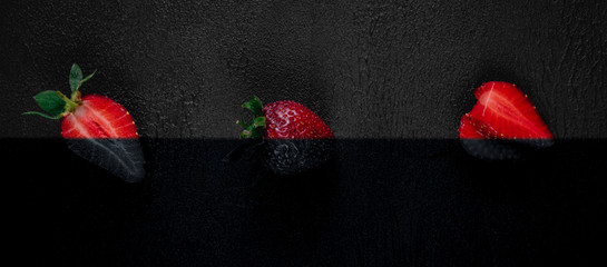 Strawberry on dark background. Top view. Copy space for text message. Colorful, black and white.  Creative concept.