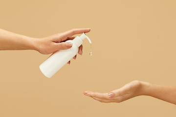 Antiseptic. Female Hands Using Gel Sanitizer On Beige Background. Daily Hygiene Routine With Antibacterial Products For Virus Prevention And Staying Healthy.