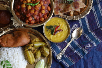 Indian gastronomic tourism. abundance of national Indian cuisine on a dark blue background. dinner in an expensive restaurant of traditional Indian cuisine. dal, sabji, parantha. copy space