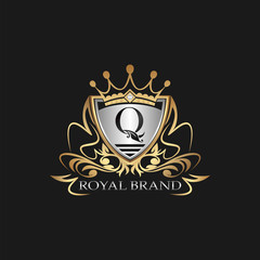 Q Letter Gold Shield Logo. Elegant vector logo badge template with alphabet letter on shield frame ornate vector style  design.