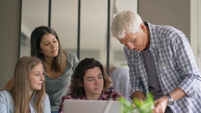 group of students working with a teacher