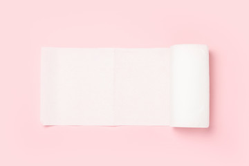 Roll of paper towels on a pink background. Concept is 100% natural product, delicate and soft. Flat lay, top view. Banner