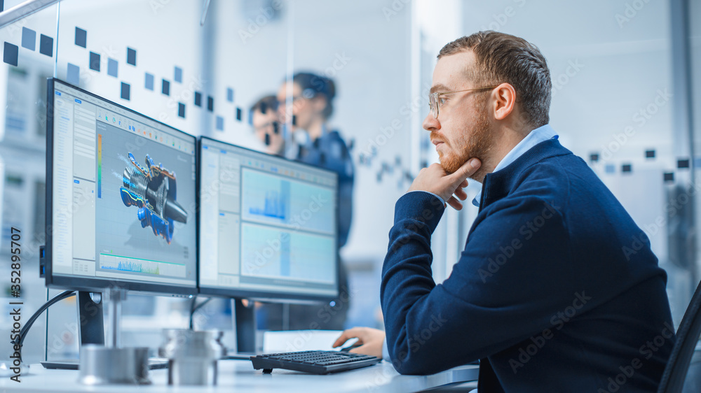 Poster Industrial Engineer Working on a Personal Computer, Two Monitor Screens Show CAD Software with 3D Prototype of Hybrid Electric Engine and Charts. Working Modern Factory.