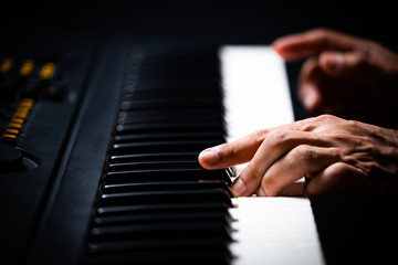 professional male pianist hands playing on piano keys. music background