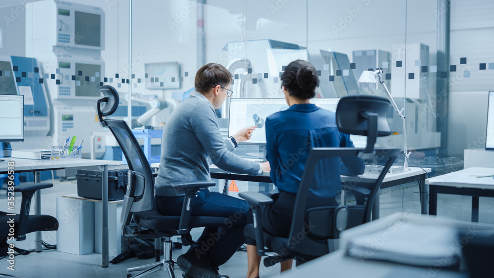 Leinwandbilder modern factory: female project supervisor talks to a male industrial engineer who works on personal 