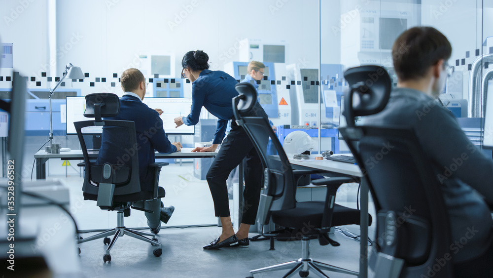 Poster modern factory: female project supervisor talks to a male industrial engineer who works on computer.