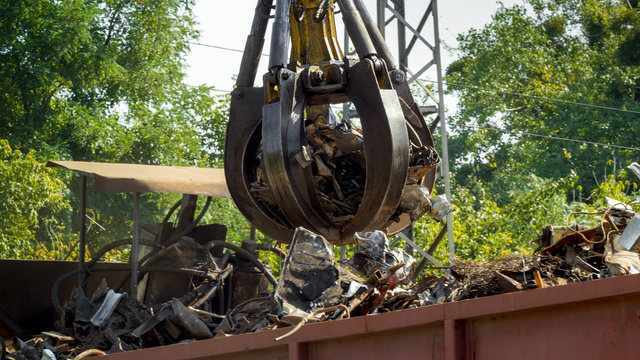 Special hydraulic claw lifting and destroying metal on scrapyard