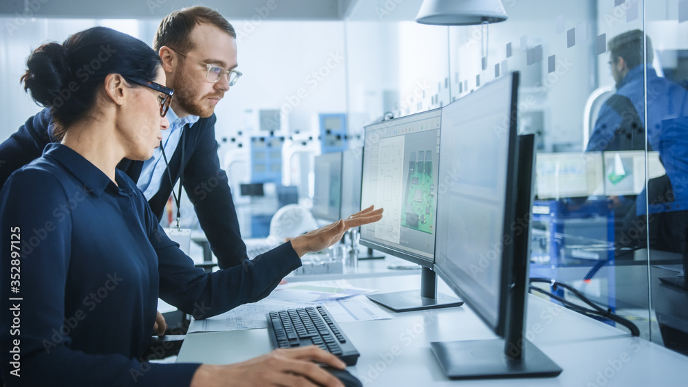 Poster modern electronics factory: male supervisor talks to a female electrical engineer who works on compu