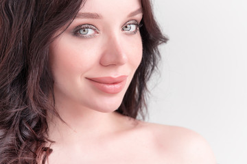 large portrait of a beautiful white young brunette girl against a white background