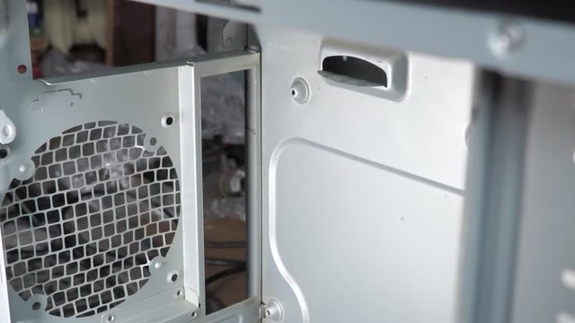 hands in white gloves, remove the inside of the PC case, metal holes for the motherboard connectors