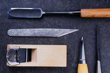 Collection of Japanese carpentry tools on a stone surface. Woodworking, craftsmanship concept, flat...