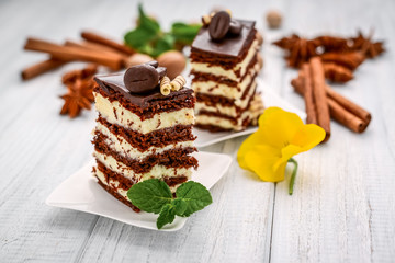 A slice of chocolate honey cake with custard
