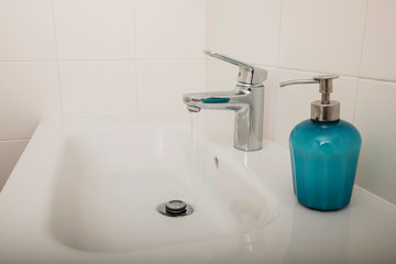 Interior of bathroom with sink basin faucet and blue soap. Design of bathroom
