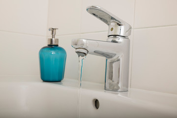 Interior of bathroom with sink basin faucet and blue soap. Design of bathroom
