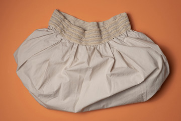 Brown skirt on orange background