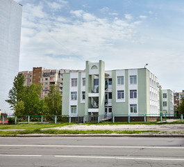 Obraz na płótnie Canvas Facade of a East European kindergarten building. Apartment buildings on a sunny day with a blue sky
