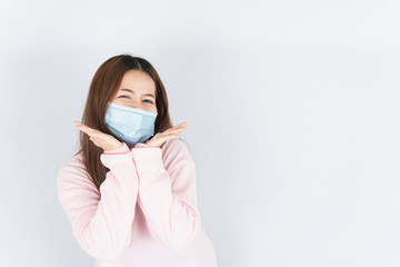 Asian beautiful happy hipster woman wearing a medical protection face mask for protect the...