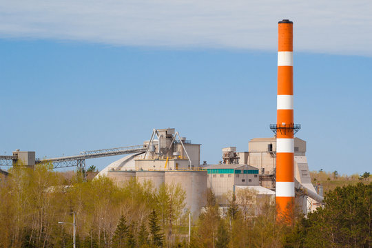 Industrial cement plant buildings and smoke stack  