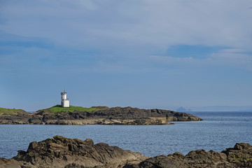 Small lighthouse on the seashore