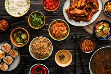top view of korean traditional dishes near chopsticks and cotton napkin on wooden surface - obrazy, fototapety, plakaty
