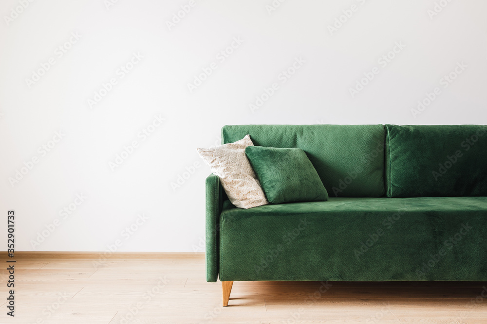 Wall mural modern green sofa with pillows in spacious room