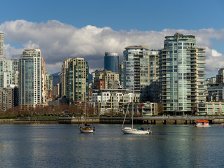 Fototapeta na wymiar Boats on False Creek with skyscrapers in the background, Vancouver, Lower Mainland, British Columbia, Canada