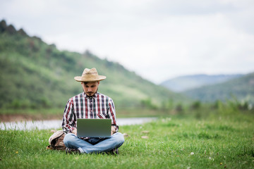 Man freelancer working on laptop in the mountains, remote work concept, text spase