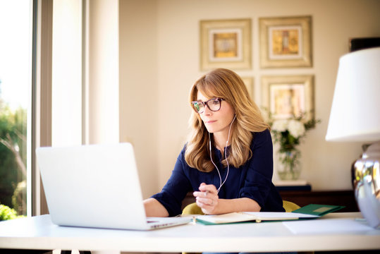 Shot Of Woman Sitting Behind Her Laptop And Working From Home