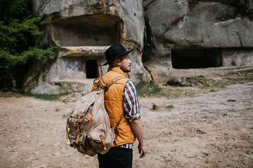 Fototapeta premium Portrait of a young man in the mountains. Travel concept