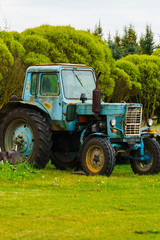 Rural life. Old tractor in the outback of Latvia.May 2020.