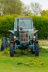 Rural life. Old tractor in the outback of Latvia.May 2020.