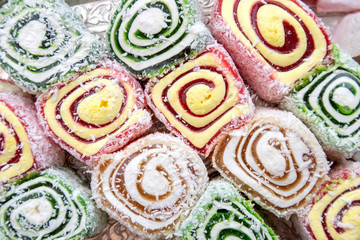 Turkish Delight rolls background closeup. Traditional sweets