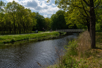 Country scene of small village bridge across river.