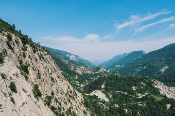 Obraz premium A picturesque landscape view of the valley of Var in the Alps mountains on a sunny summer day (Puget-Theniers, Alpes-Maritimes, France)
