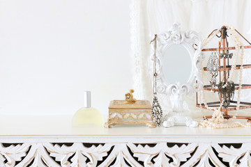 Image of white vintage mirror and pearls over wooden table. For mockup, can be used for photography montage