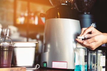 Woman uses her hand to press hand sanitizer bottle to clean her hand in coffee shop. Hand sanitizer alcohol gel rub clean hands hygiene prevention of coronavirus (Covid-19) virus outbreak.