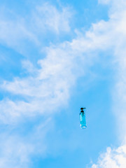 Antiseptic alcohol bottle floating on blue sky background, Campaign to prevent the spread of the Corona virus (Covid-19). New normal concept.