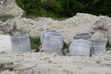 Iron concrete rings. Construction of sewerage system.