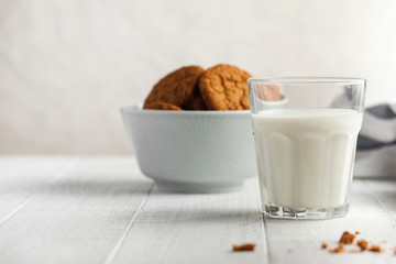  Glass of milk, cookies in a bowl on a light background. The concept of dairy products, farm products. Copy space.