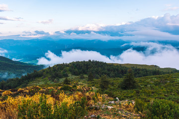 A picturesque wide landscape view of the French Alps mountains covered in clouds in the evening (Col de Rigaudon, Alpes-Maritimes, France) © k.dei