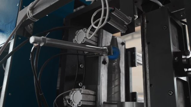 Pure water plant. Work conveyor boosting a liter plastic bottle. Workers monitor the assembly line. 4k