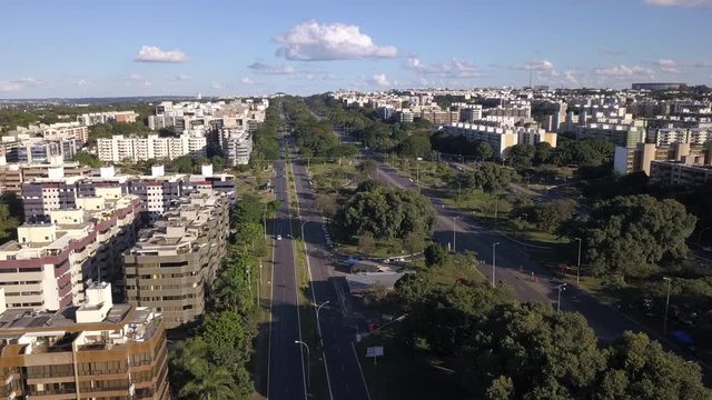 Beautiful drone aerial view of Brasilia city skyline with "Eixao, Eixo Rodovi&aacute;rio" closed road axis for leisure on sunny summer day. Concept of urban, modern, cityscape, architecture, landmarks.