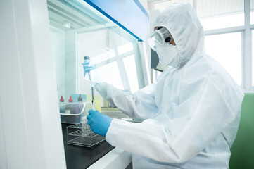 Selectve focus scientist wearing personal protection equipment(PPE) making laboratory in the...