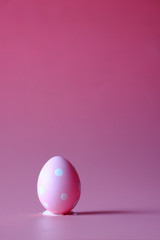 easter concept with egg on pink background.