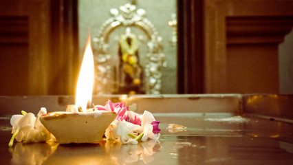 A close up of candle burning on floor