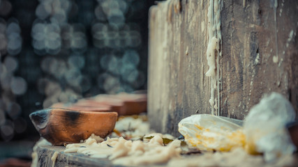 A close up of candle cup on stone