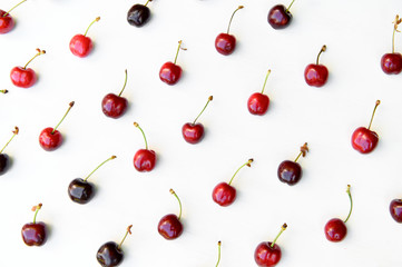 Juicy, ripe, beautiful sweet cherries on a white wooden background.