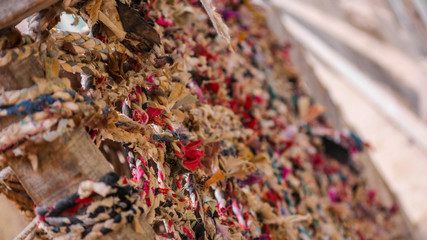 A close up of colourful rope tied on wood