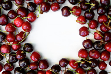 Juicy, ripe, beautiful sweet cherries on a white wooden background. Copy space