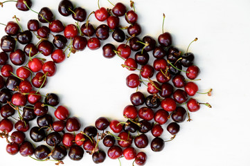 Juicy, ripe, beautiful sweet cherries on a white wooden background. Copy space